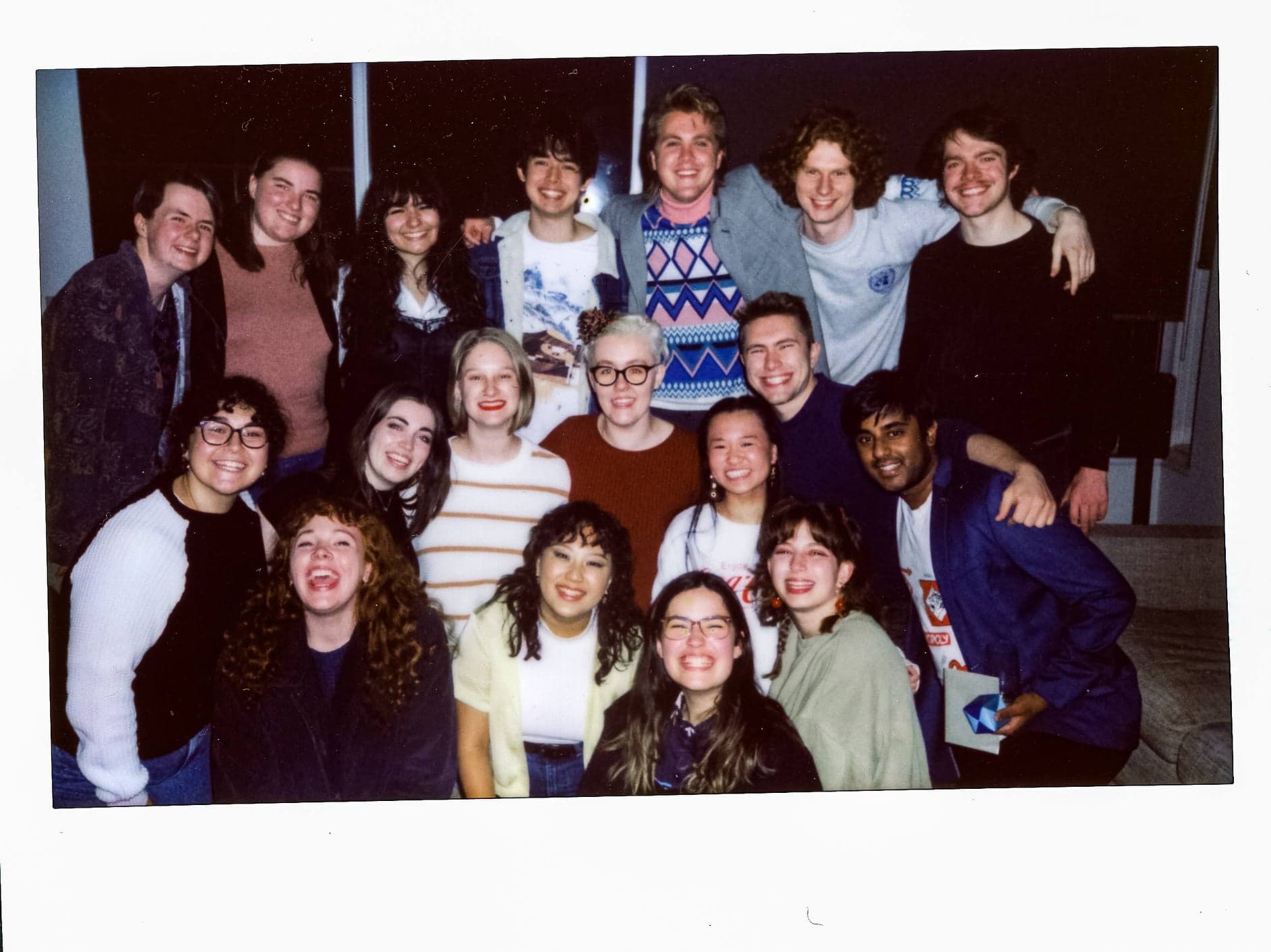 A group photo of some of the Sequence Break team shows 18 people huddled together, smiling.